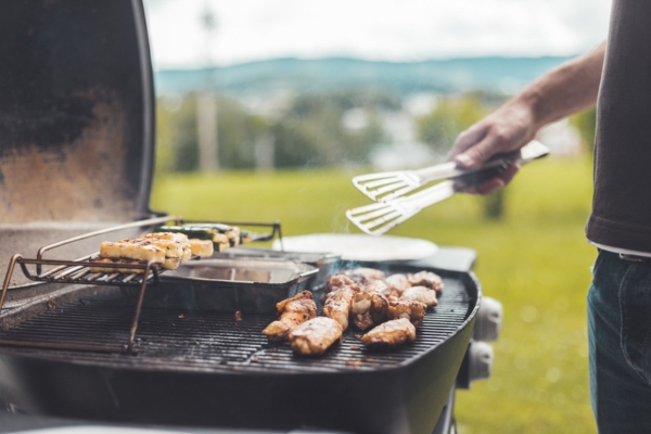 close up of a man grilling with propane