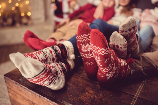 family in wool socks lounging on the couch depicting energy efficient heater