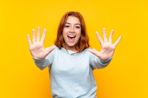 young lady holding 10 fingers up depicting 10 Practical Strategies for propane heating cost savings