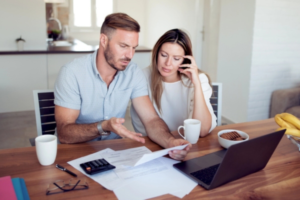 stressed couple while looking at energy bill