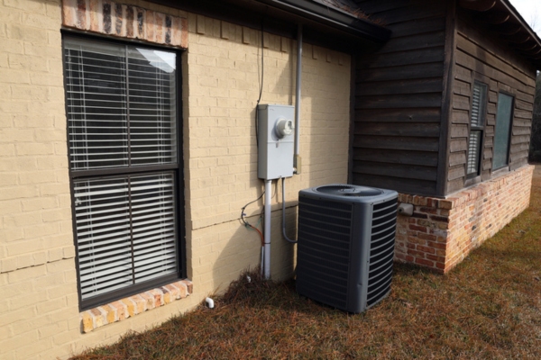 outdoor air conditioner unit beside a house