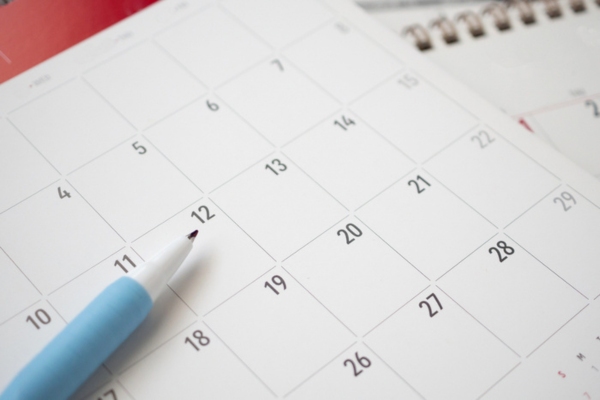 calendar page with a pen on top depicting Skipping Routine Air Conditioner Maintenance