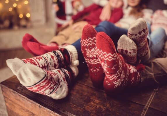 family in wool socks lounging on the couch depicting energy efficient heater